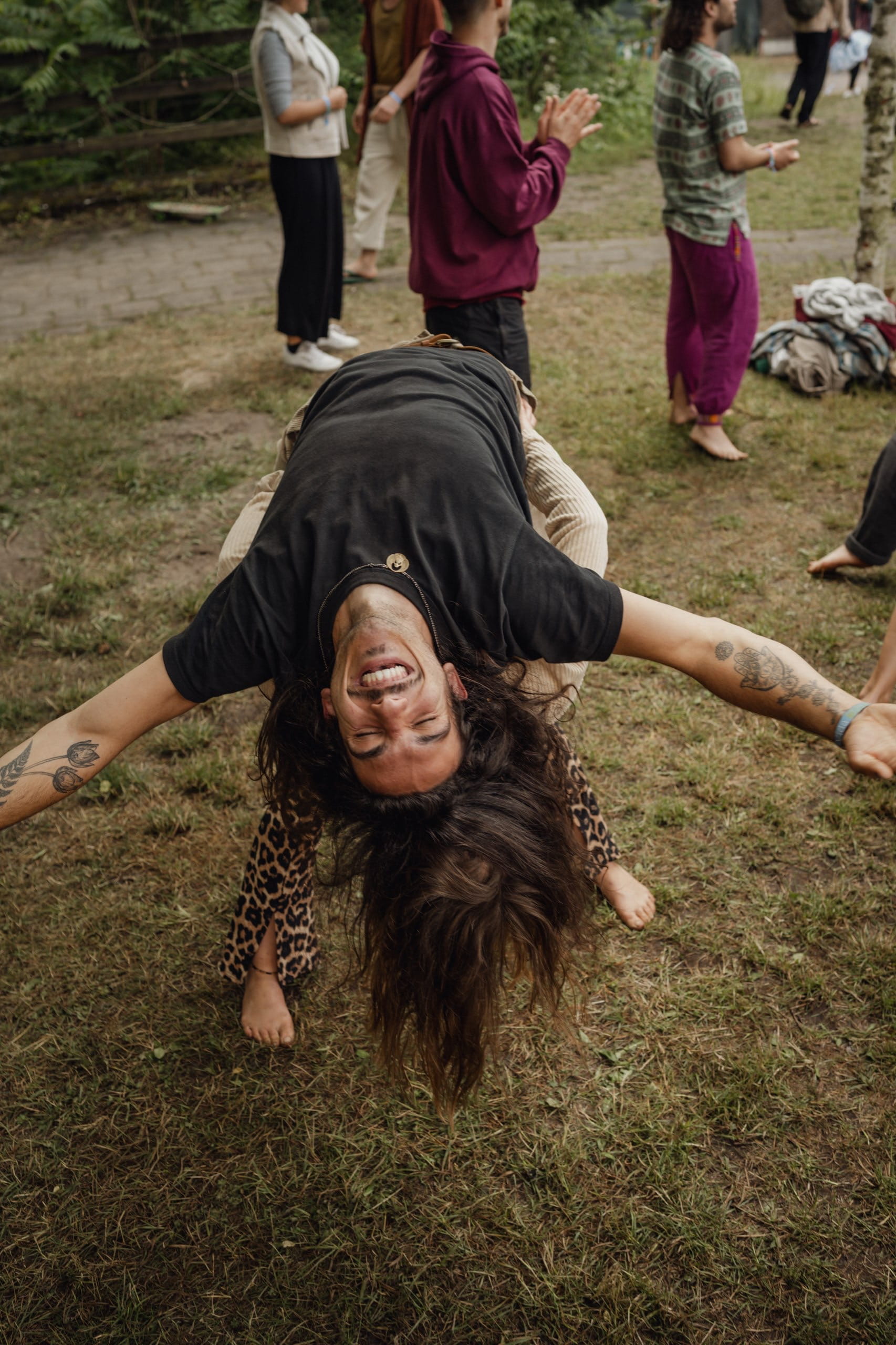 A man is laying on the back of a woman arms wide spread