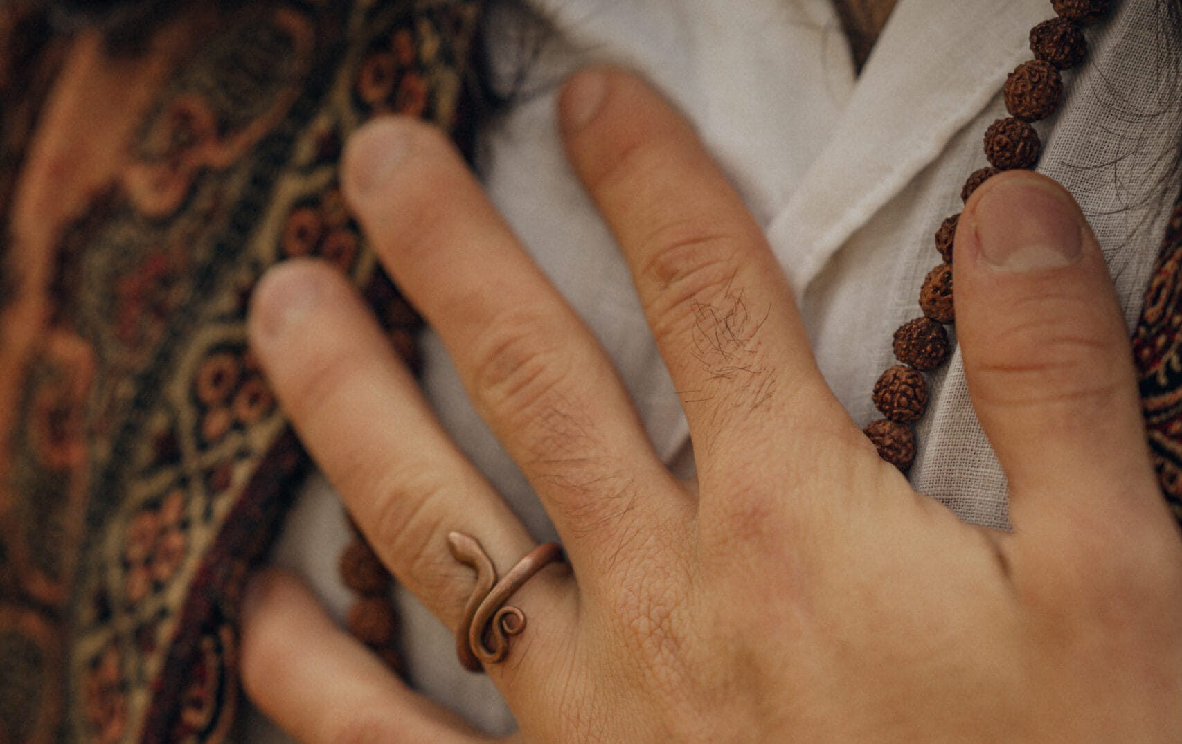 A hand lies relaxed on the chest