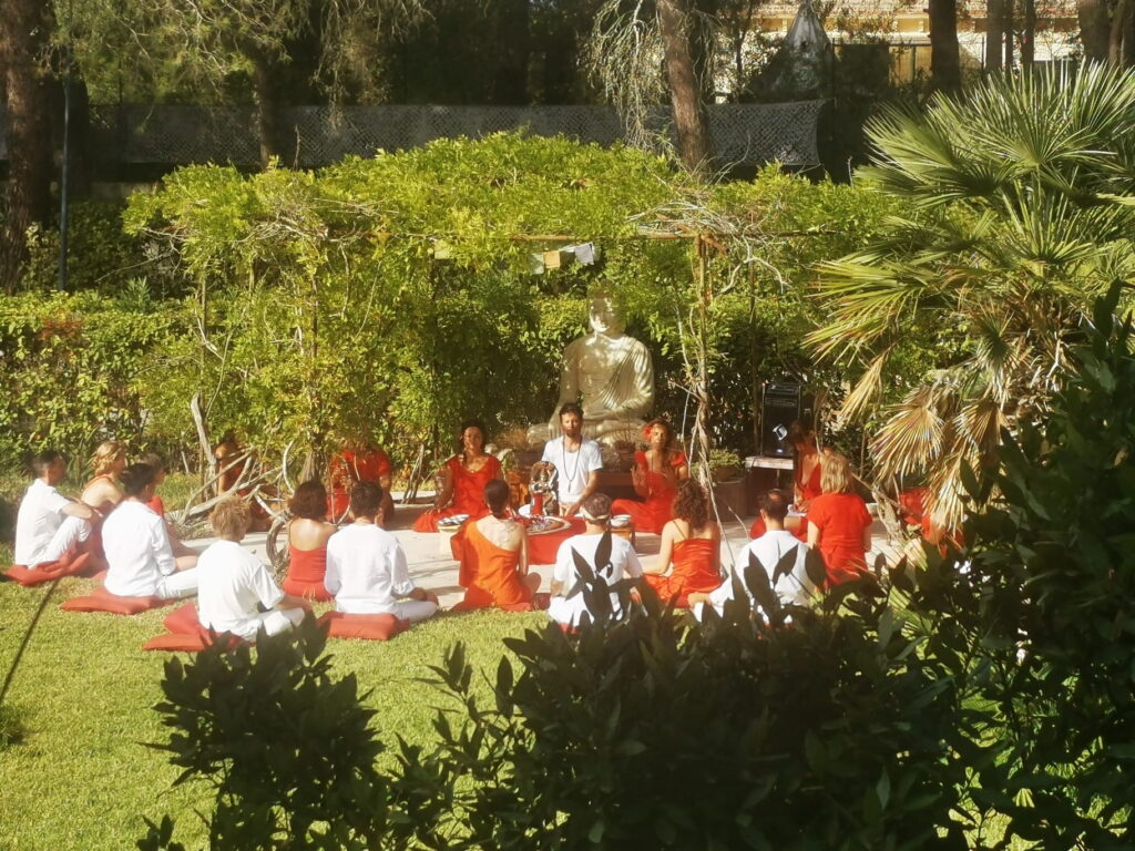 Tantric lesson in an outdoor Tantra Teacher Training, with Nico Loewer assisting his teachers in a rondel