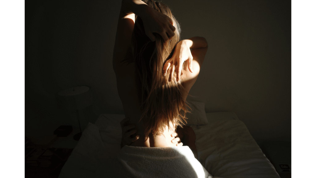 Sensual encounter of a couple in a bedroom setting, shown from behind with natural movement, expressing intimacy and embodied connection