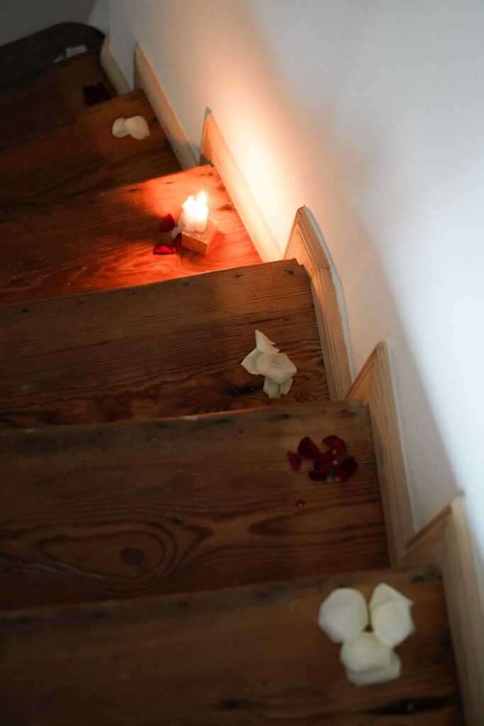 Staircase with candles and rose petals as a consciously designed workshop space for Tantra and Embodiment practice